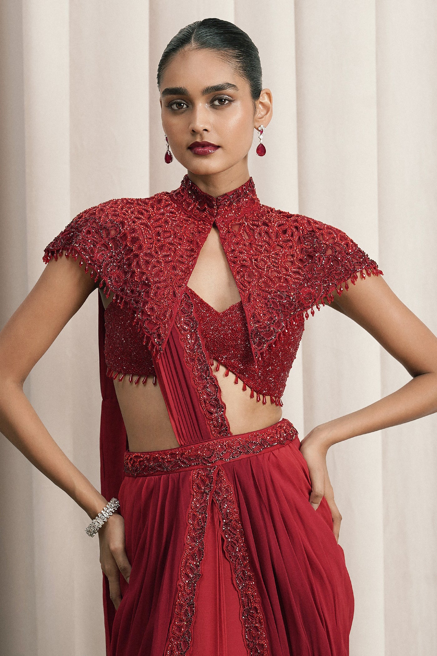 RED DRAPED SAREE WITH CAPE AND BUSTIER