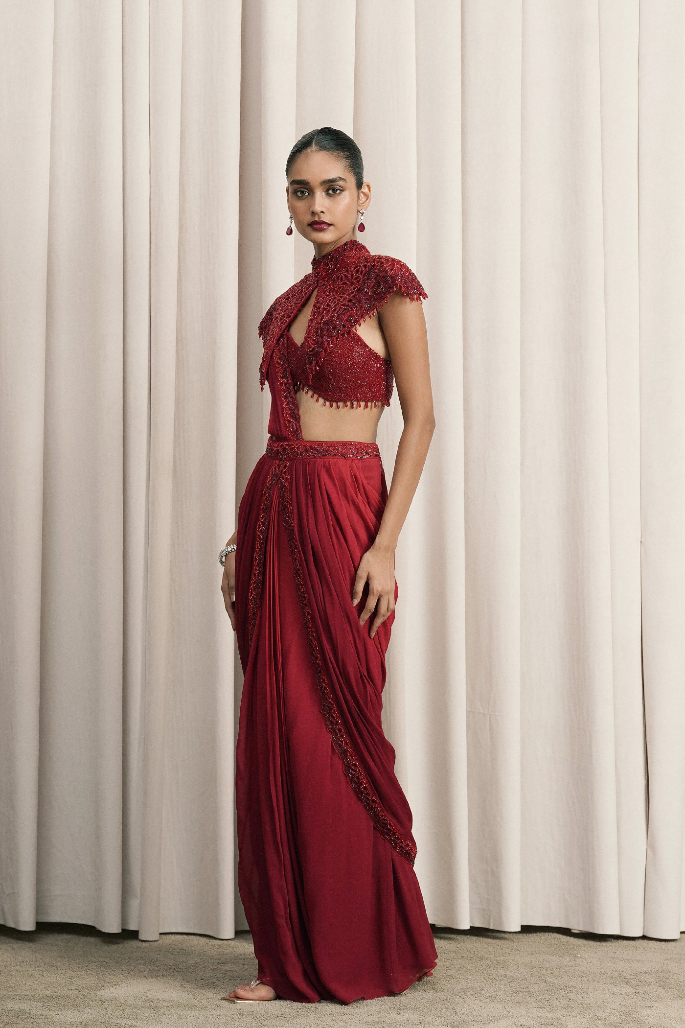 RED DRAPED SAREE WITH CAPE AND BUSTIER