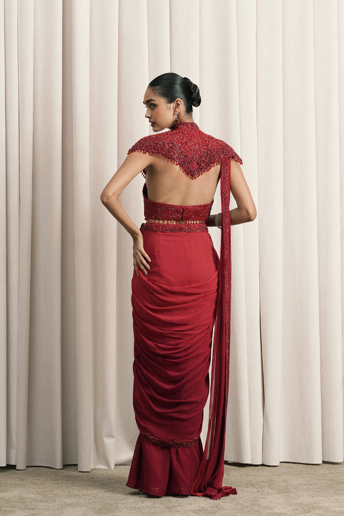 RED DRAPED SAREE WITH CAPE AND BUSTIER
